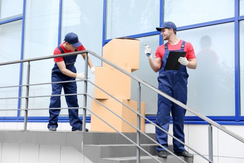 Professional packers carefully managing items for storage