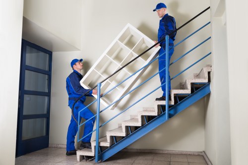 Professional movers handling office equipment in Putney